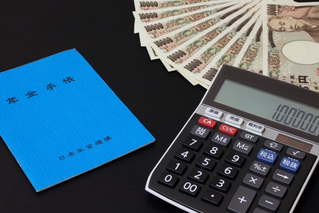 Pension book, calculator and money